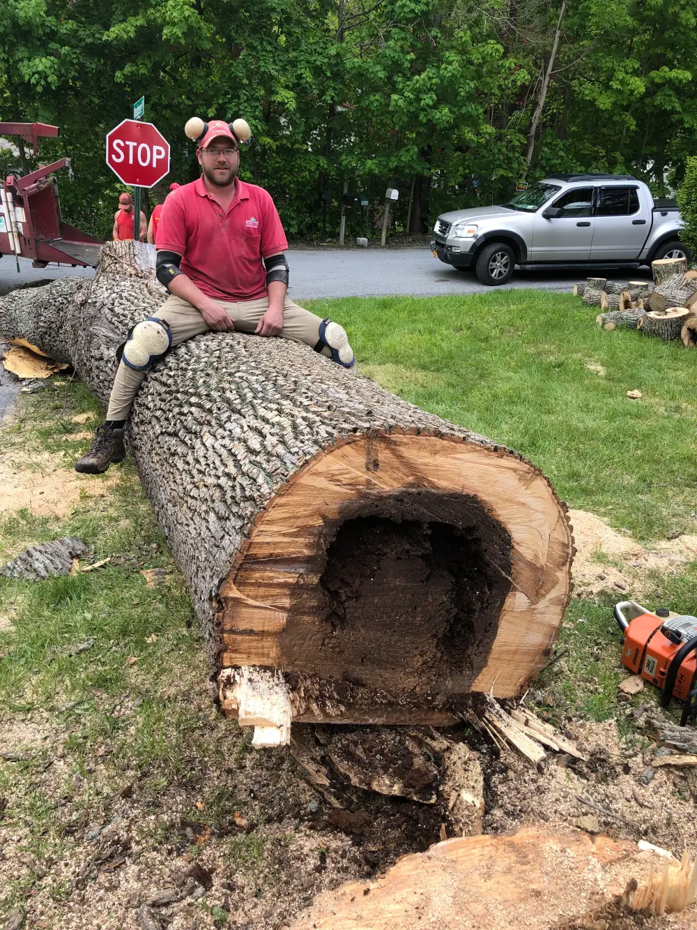 A man sitting on top of a log.